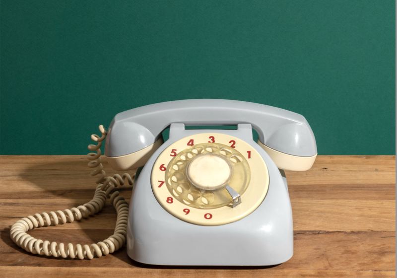 retro dial up telephone on wooden surface